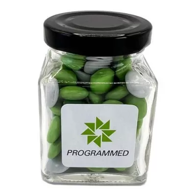 branded 100g Chocolate Beans Packed in Small Glass Square Jars, from our range of promotional Branded Chocolates