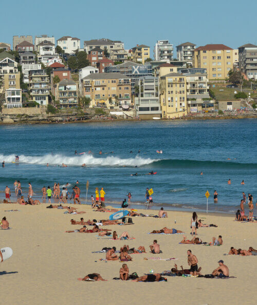 Swimmers and beachgoers on a busy day at Bondi Beach Sydney